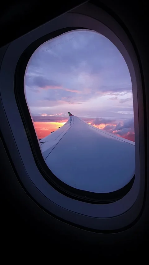 Dramatic sky colors during sunset, window plane view Stock Footage 299563127