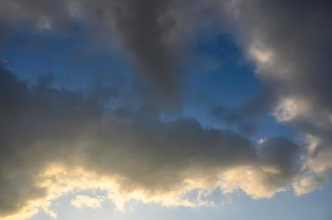 Dramatic sky with combination of dark dense clouds and bright breaks lighti.. Stock Photos