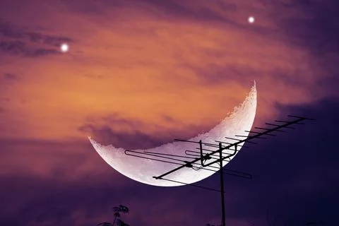 Dramatic Sky with Crescent Moon and Antenna Silhouette at Dusk Stock Photos