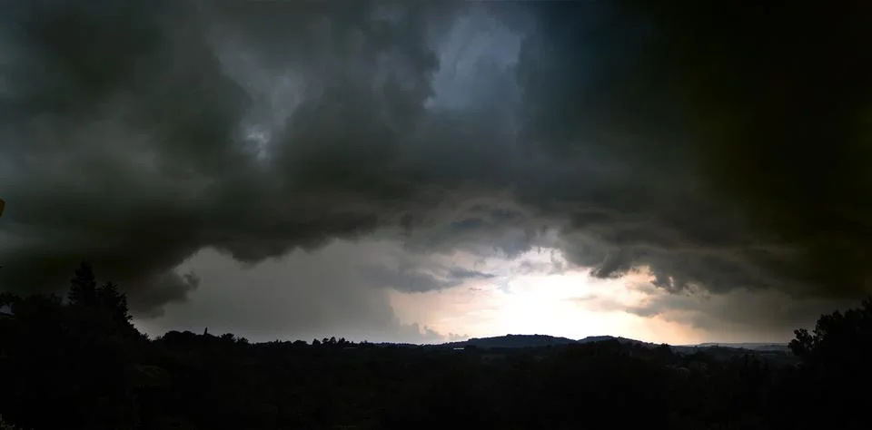 Dramatic sky, cyclone. Gray storm clouds filled with rain. Stock Photos