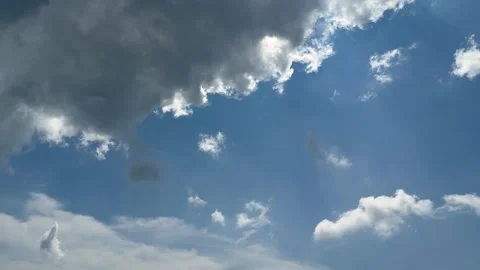 Dramatic sky with dark clouds and patches of bright blue creating a strikin.. Stock Footage 339369031