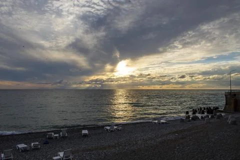 Dramatic sky with dark clouds on calm sea at sunset. Black Sea coast, early a Stock Photos