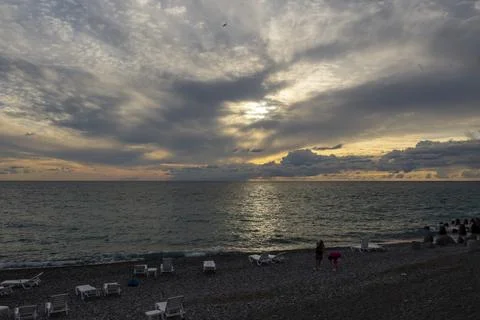 Dramatic sky with dark clouds on calm sea at sunset. Black Sea coast, early a Stock Photos