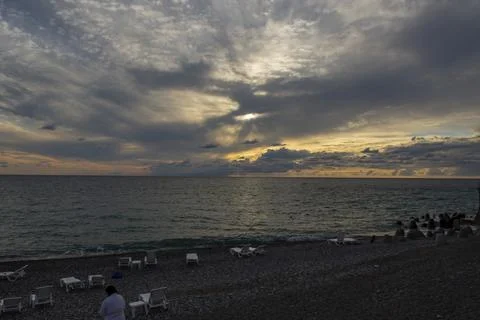 Dramatic sky with dark clouds on calm sea at sunset. Black Sea coast, early a Stock Photos