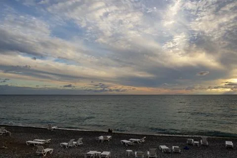 Dramatic sky with dark clouds on calm sea at sunset. Black Sea coast, early a Stock Photos