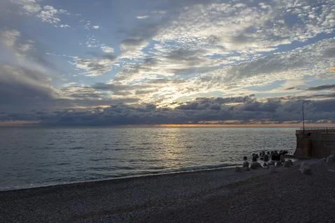 Dramatic sky with dark clouds on calm sea at sunset. Black Sea coast, early.. Stock Photos