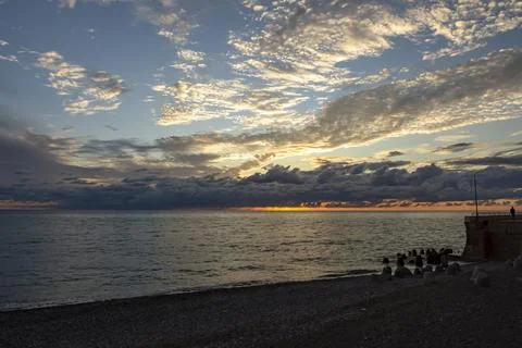 Dramatic sky with dark clouds on calm sea at sunset. Black Sea coast, early.. Stock Photos