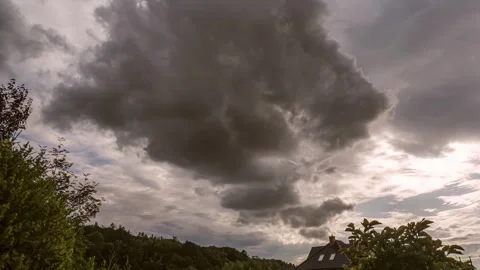 Dramatic Sky with Dark Storm Clouds Over Landscape and Roofline Видео 312929521