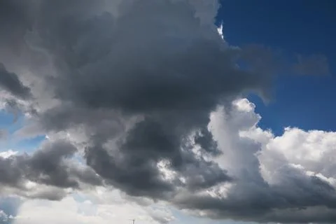 Dramatic Sky with Dark Storm Clouds and Sunlight Breaking Through 스톡 사진
