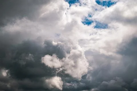 Dramatic sky with dark storm clouds gathering against a bright blue sky Stock-Fotos