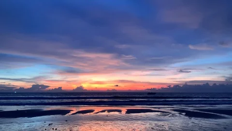 Dramatic sky with dawn sunset. one lonely person walking by the beach of the sea Stock Footage 129077114