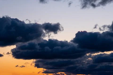 Dramatic sky during sunset. Big dark clouds on orange - blue sky background. Foto stock