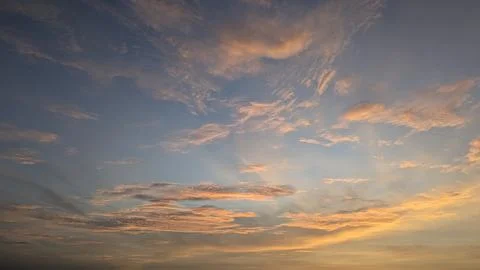 A dramatic sky features bright orange, yellow colors near the horizon. Text.. Photos