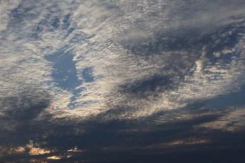 Dramatic sky filled with cirrocumulus clouds and patches of blue Stock Photos