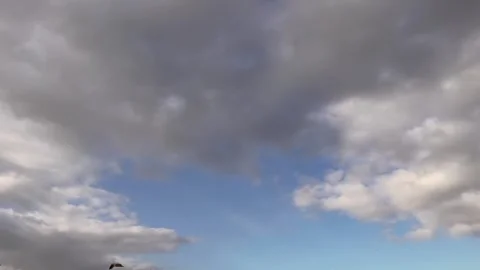 A dramatic sky filled with dark, swirling clouds. 스톡 동영상 293275613