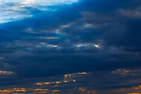 Dramatic sky filled with deep blue and gray clouds Stock Photos