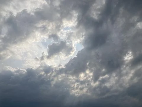 Dramatic sky filled with dense, textured clouds, covering frame Sunlight fi.. Stock Photos