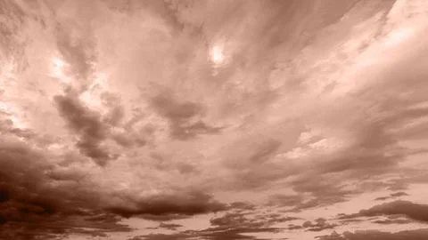 Dramatic sky filled with textured clouds, tinted in soft brown mocha hues. Foto stock