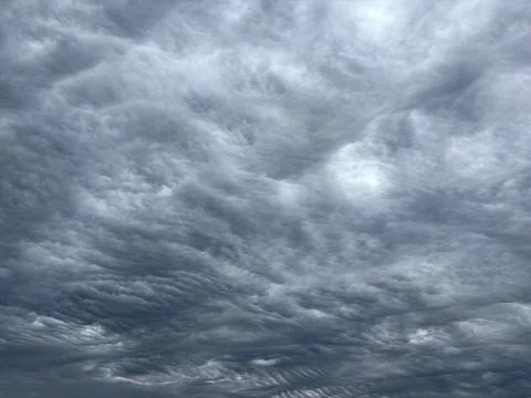 A dramatic sky filled with thick, swirling storm clouds 스톡 사진