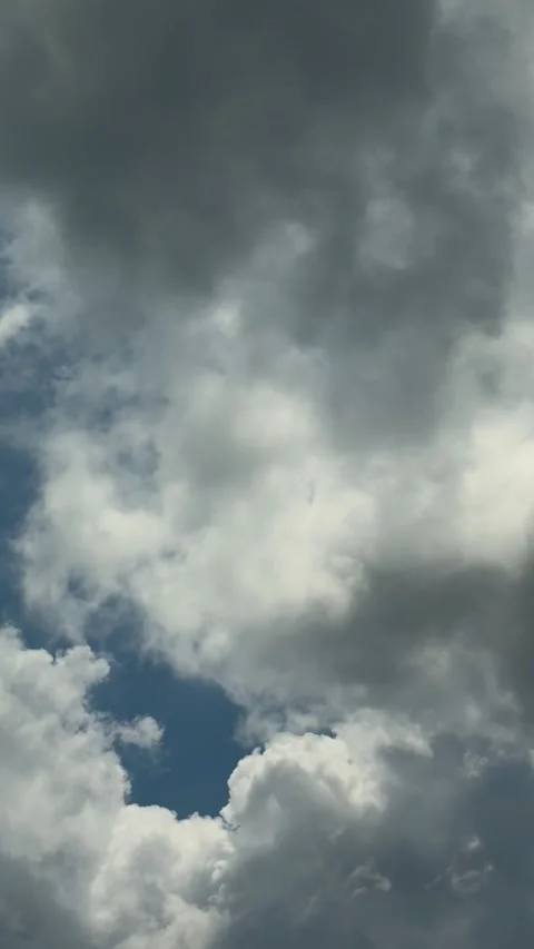 Dramatic sky with fluffy white clouds against a deep blue background in a s.. Stock Footage 338414410