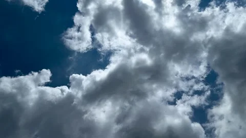 Dramatic sky with fluffy white clouds against a deep blue background on a s.. Stock Footage 339369038