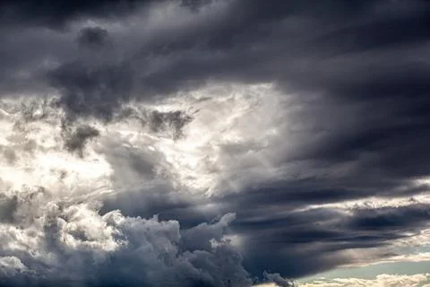Dramatic sky with grey clouds over the city before the storm. Stock Photos