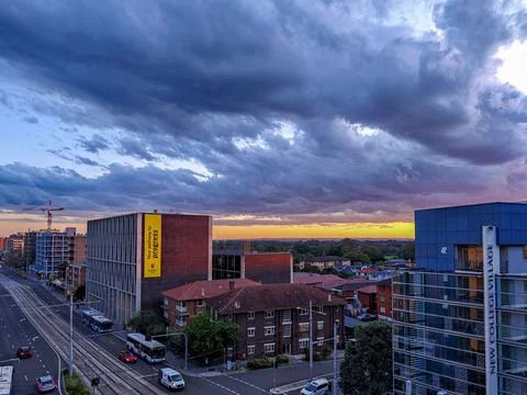 Dramatic sky with intense sunset colors over suburban buildings 스톡 사진