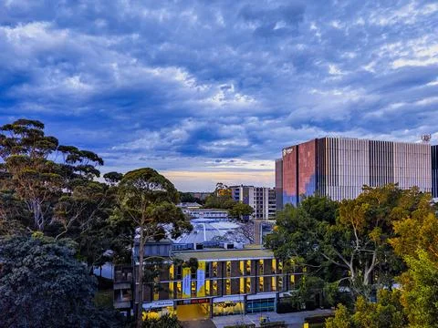 Dramatic sky with intense sunset colors over suburban buildings Stock Photos