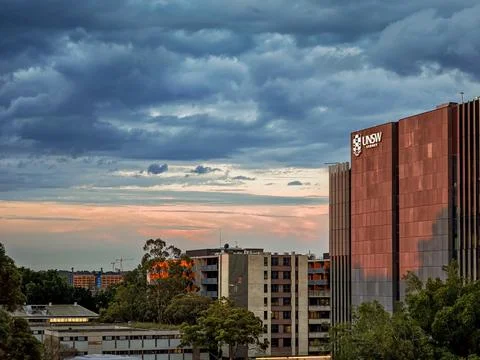Dramatic sky with intense sunset colors over suburban buildings Stock Photos