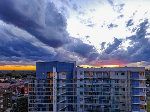 Dramatic sky with intense sunset colors over suburban buildings Fotos Stock