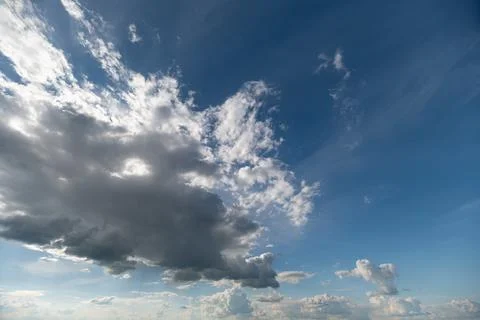 Dramatic sky with large cumulus cloud and scattered cirrus over horizon 写真素材