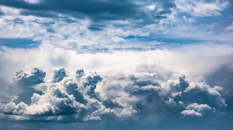 Dramatic sky, light from heaven. Cumulus stormy clouds in summer Stock Photos