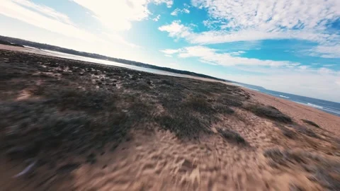 Dramatic sky meets calm water and soft sand Stock Footage 340905145