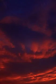 Dramatic sky with orange clouds after sunset Stock Photos