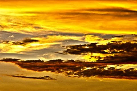 Dramatic sky with orange clouds at sunset Stock Photos