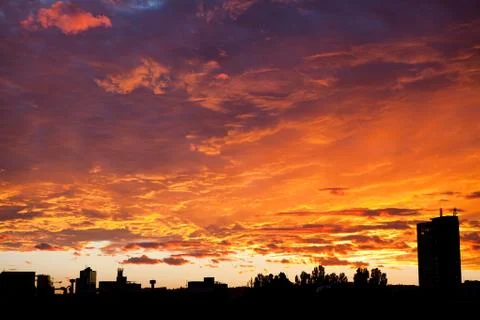 Dramatic sky in orange color. Sunset in the city - natural background Stock-Fotos