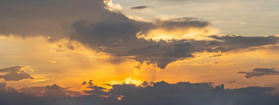Dramatic sky with orange sunlight at the sunset Stock Photos