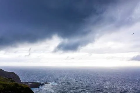 Dramatic sky over Atlantic Ocean coast near Sao Miguel Island, Azores, Portug Stock Photos