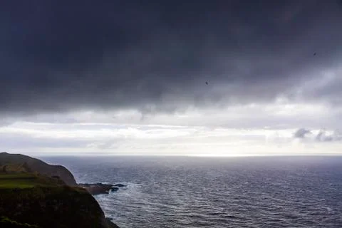Dramatic sky over Atlantic Ocean coast near Sao Miguel Island, Azores, Portug Stock Photos