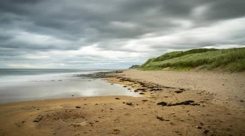 Dramatic sky over a beach Dramatic sky over a beach, seen at Cocklawburn B... Stock Photos