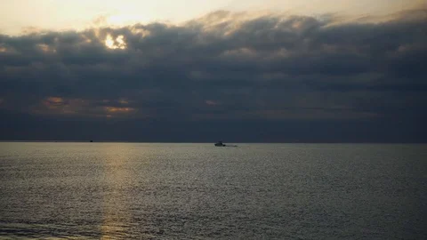 Dramatic Sky Over the Calm Sea And Boat Moving Stock Footage 115126061