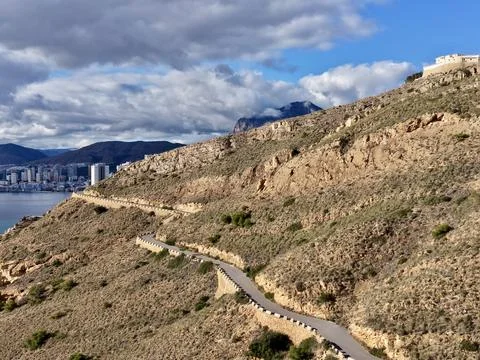 Dramatic sky over craggy cliffs, Foreboding atmosphere with contrasting shadows Stock Photos
