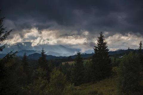 Dramatic Sky Over Forested Mountain Landscape Stock Photos