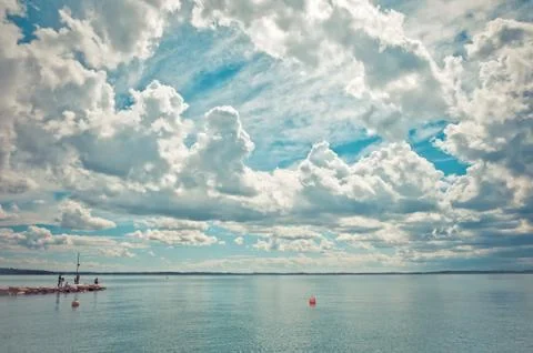 Dramatic sky over Garda lake with pier - Italy Stock Photos