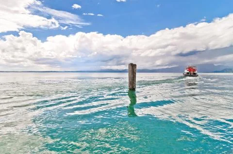 Dramatic sky over Garda lake with pole - Italy Stock Photos
