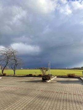 Dramatic Sky Over a Green Field Stock Photos