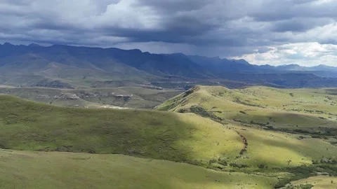 Dramatic Sky Over Green Hills. Bright Sun Highlights Shadows On Vibrant Mountain Stock Footage 335240733