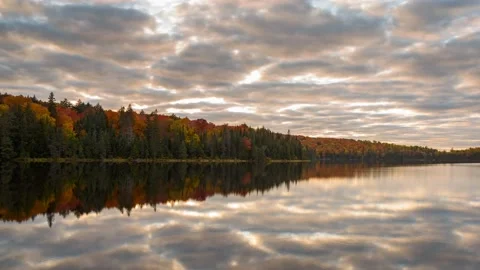 Dramatic sky over a lake at sunset. Autumn colours. Video stock 165288968