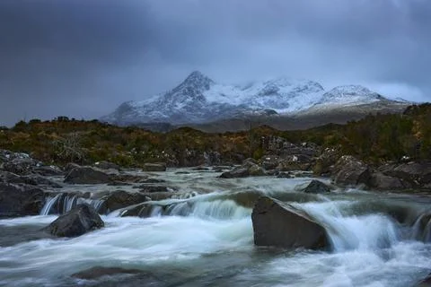 Dramatic sky over large mountains from the River Sligachan on the Isle of Sky Stock Photos