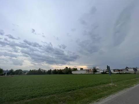 Dramatic Sky over Lush Green Field Stock-Fotos